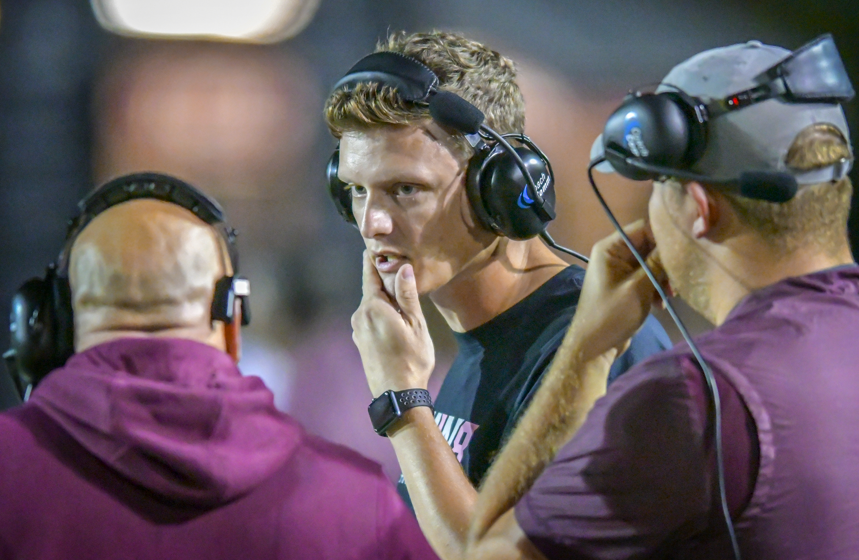 Who is the Football Coach Talking to in His Headset 